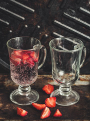  Strawberries with soda in a transparent glass
