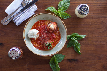 Meatball sampling with burrata mozzarella, fresh basil, and crushed red pepper