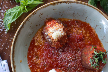 Meatball sampling with burrata mozzarella, fresh basil, and crushed red pepper