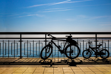Bicycles on the beach. Two bicycles parked near the sea. Family travel and healthy lifestyle concept.