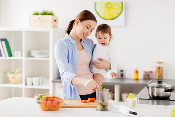 happy mother and baby cooking food at home kitchen