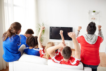 friends or football fans watching tv at home
