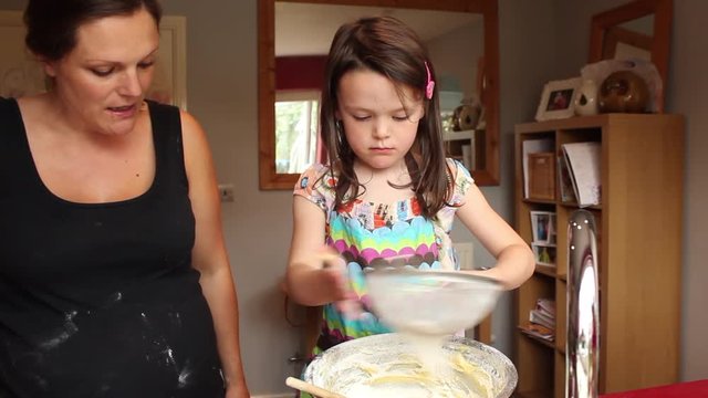 Mum on maternity leave teaching young daughter how to cook