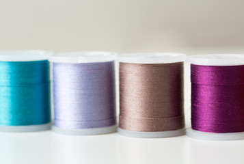row of colorful thread spools on table