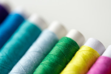 row of colorful thread spools on table