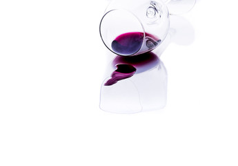 wine fell from the glass on the table, white background