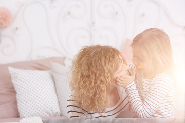 Girl touching mom's face