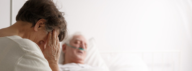 Obraz na płótnie Canvas Senior woman visiting her sick husband