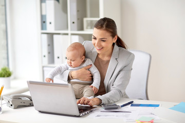 happy businesswoman with baby and laptop at office