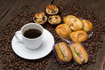 Coffee cup with bread sausage and coffee beans
