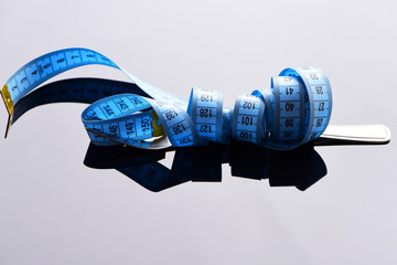 Tape for measuring wraps around metal fork