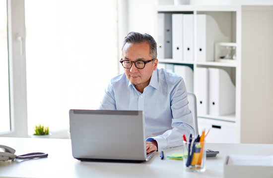 businessman in eyeglasses with laptop office