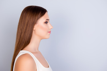 Fototapeta premium Close up profile portrait of young pretty lady in white casual singlet on pure background with copy space