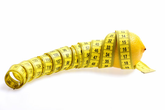 Diet concept. Tape-measure twined around lemon isolated on white
