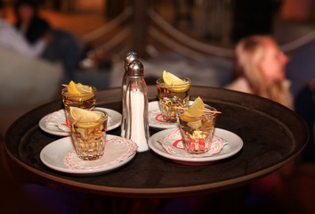 Tequila with lemon and salt, four portions on a bar tray
