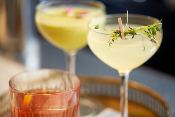 tray with glasses of cocktails at bar