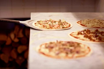 Kissenbezug peel taking pizza off table at pizzeria © Syda Productions