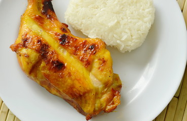 grilled chicken leg eat with sticky rice on plate