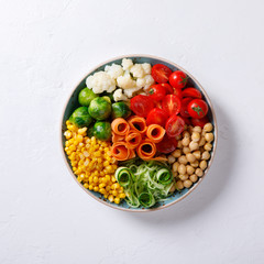  Buddha Bowl Vegetarian on a white Background. Raw Vegetables and  in chickpeas  a one bowl.Food or Healthy Diet concept.Super Food.Copy space for Text. selective focus.