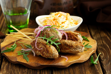 Kyufta kebab with salad close-up.
