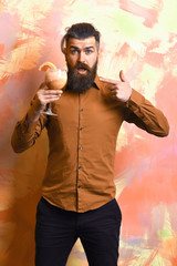 Brutal caucasian hipster holding tropical alcoholic fresh cocktail