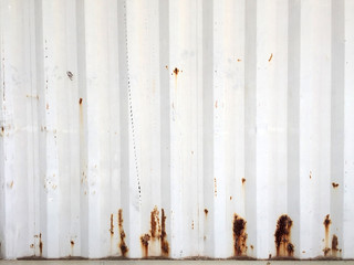 Rusty metal background with old layers of white paint. Texture rusted shipping container.