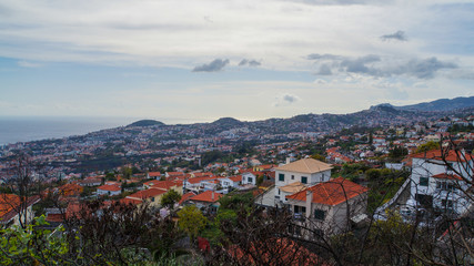 Fototapeta na wymiar Madeira - City of Funchal from Monte with houses and ocean in background