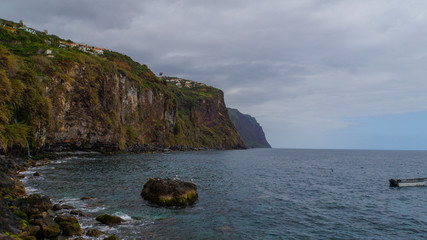 Madeira - Coast of Ribeira Brava with cliffs and a boat on the ocean