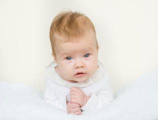 Portrait of a newborn baby girl lying on her stomach