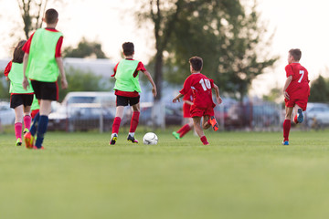 Obraz premium Kids soccer football - children players match on soccer field