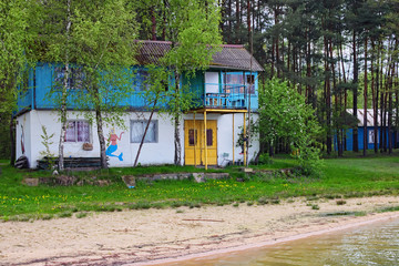Old two-storey house on the shore of the lake. Pisochne ozero. Volyn region. Ukraine