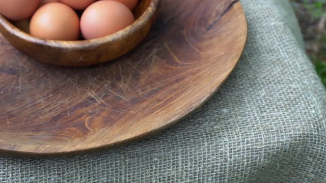Eggs in a wooden bowl on the table. Natural healthy food concept.