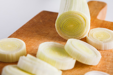 Sliced and chopped leek closeup on wood background