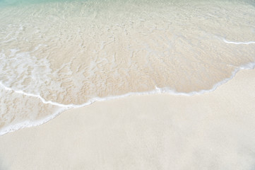 wavy sea, ocean water background on sand coast in Antigua
