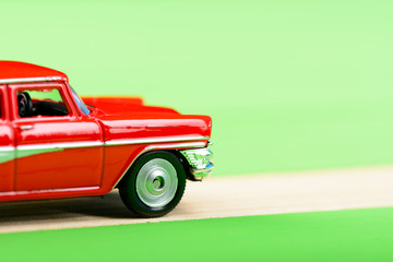 Red vintage car model on wooden boards