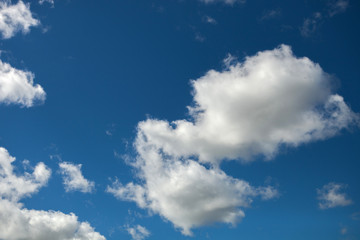 Naklejka na ściany i meble Fluffy clouds on beautirful blue sky