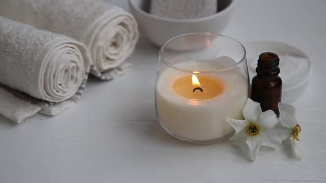 Burning candle on a spa setting