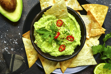 Avocado dip guacamole with tortilla chips.Top view. - obrazy, fototapety, plakaty
