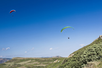 Paragliding in blue cloudy sky