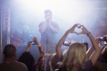 Male singer performing in front of crowd at nightclub