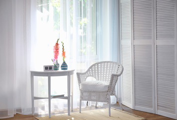 White chair in a room with flowers