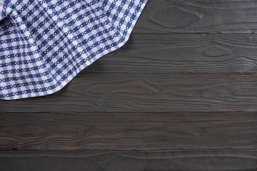 blue cloth on dark wooden background with copy space. Top view.