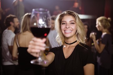 Portrait of smiling young woman holding wineglass