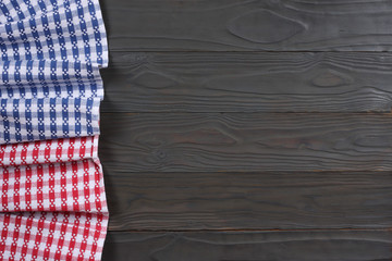 blue and red cloth on dark wooden background with copy space. Top view.