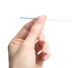 Female hand with needle for acupuncture on white background