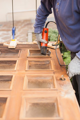 Carpenter at work with angular Sander.