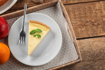 Composition with tasty cheesecake on wooden table