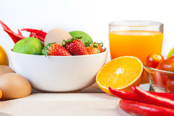 Healthy concept with mixed fruits and vegetables on wooden background