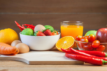Healthy concept with mixed fruits and vegetables on wooden background