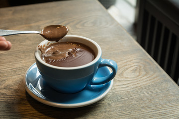 Blue Cups of hot Chocolate drink on dark wooden background. Morning time. Holiday concept